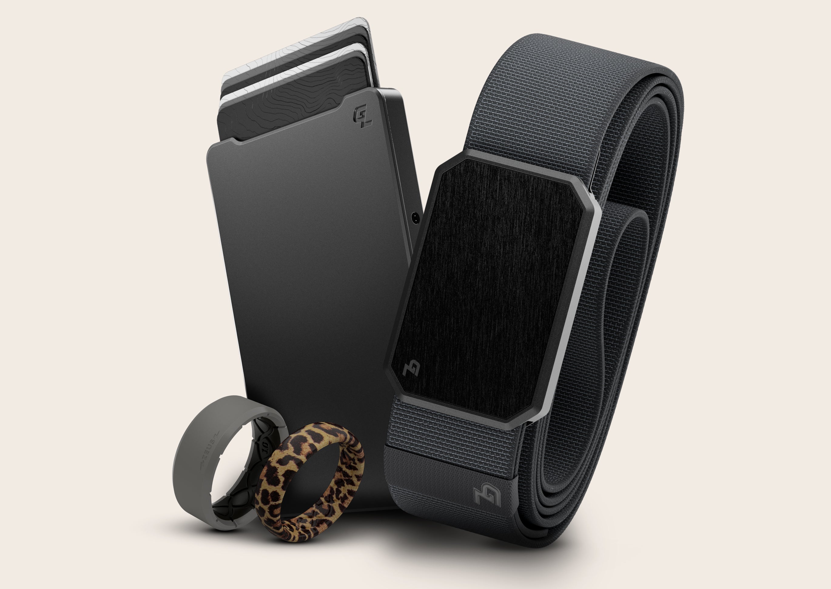 black belt, black slim metal wallet, leopard ring, and grey ring.