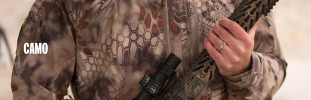 Camo, man holding a large rifle in kryptek camouflage