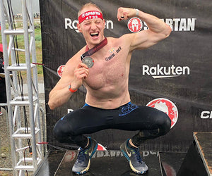 Seth Buchwalter poses with the silver medallion he won at a Spartan Race