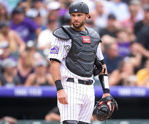 Drew Butera stands and looks off camera while dressed in his catcher's gear